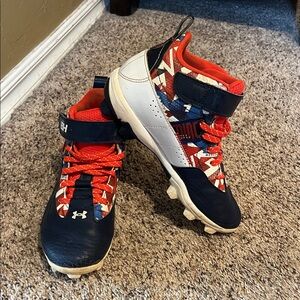 Boys under armour baseball cleats 
Red white blue